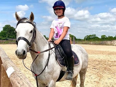 Girl in arena at wapley stables livery